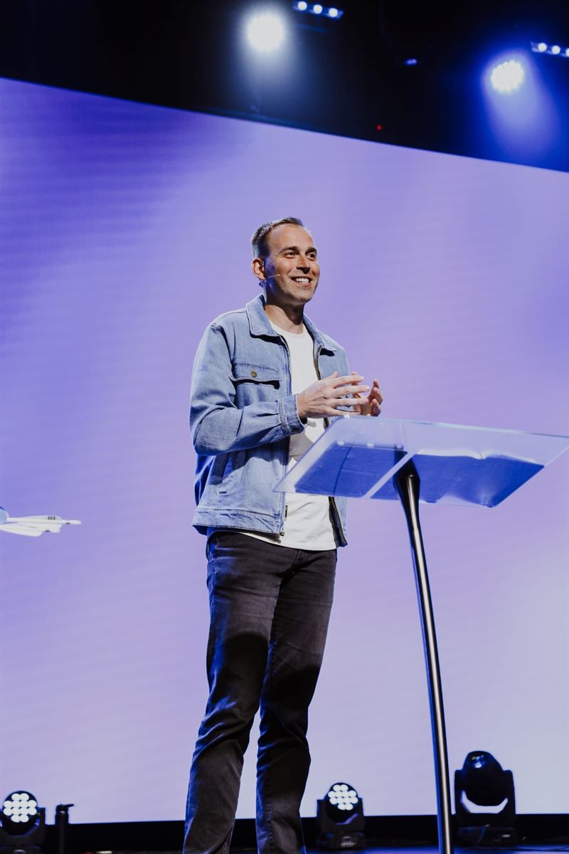 Jonathan Hardy speaking from a stage